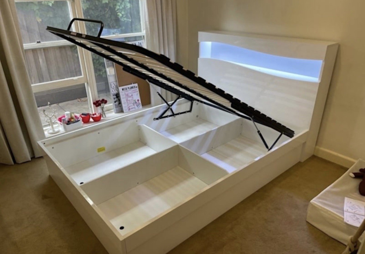 Lift-up storage bed showing internal compartments